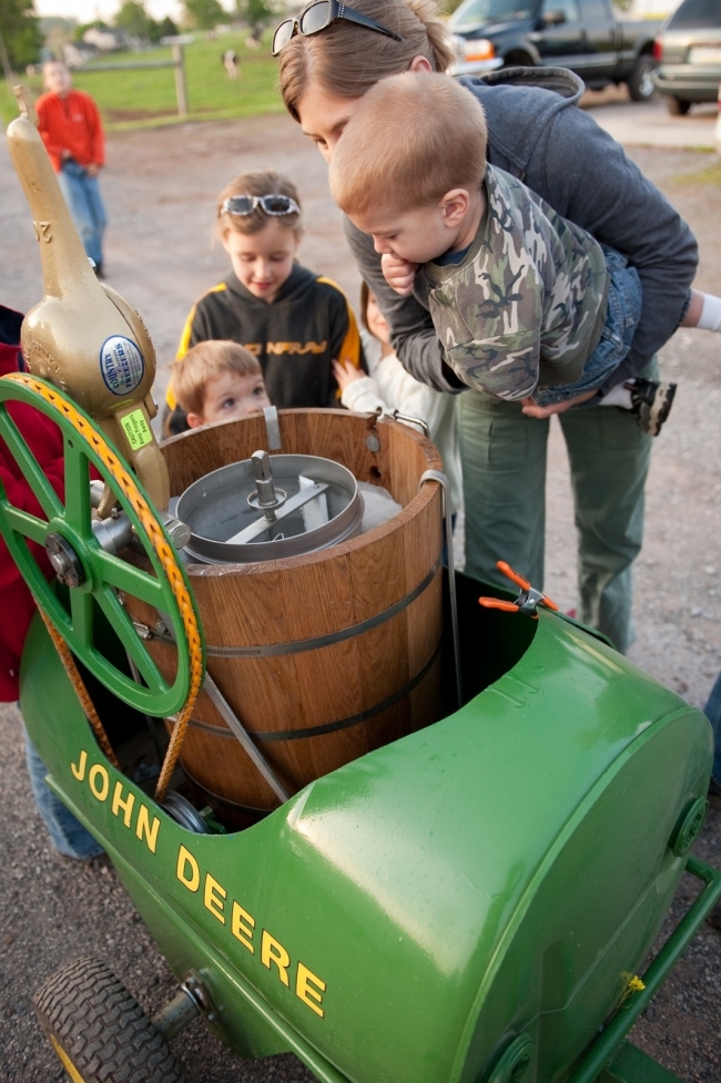 20 quart ice cream churn in a cart drewn by small tractor.